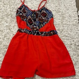 Adorable red romper with bright pattern